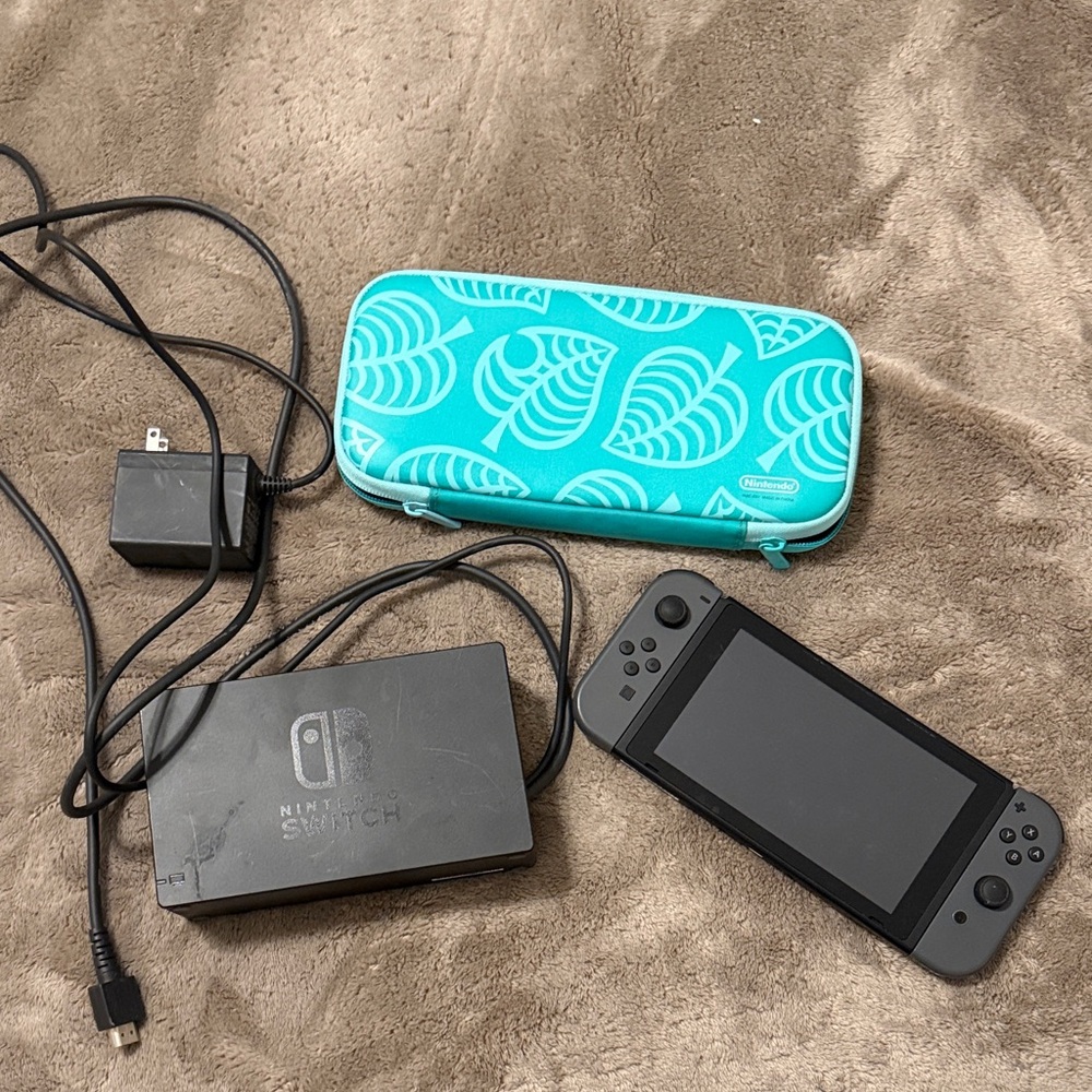 Nintendo Switch with Black Joy-Con and Turquoise Case